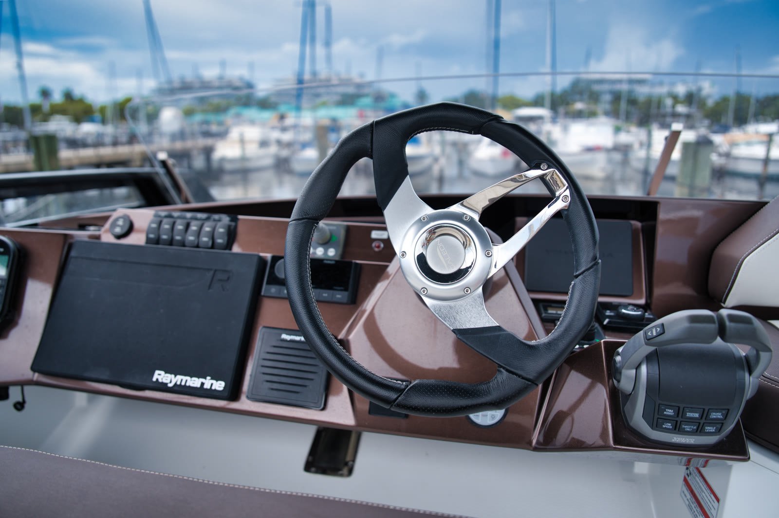 The helm with its wheel, throttles and navigation screens
