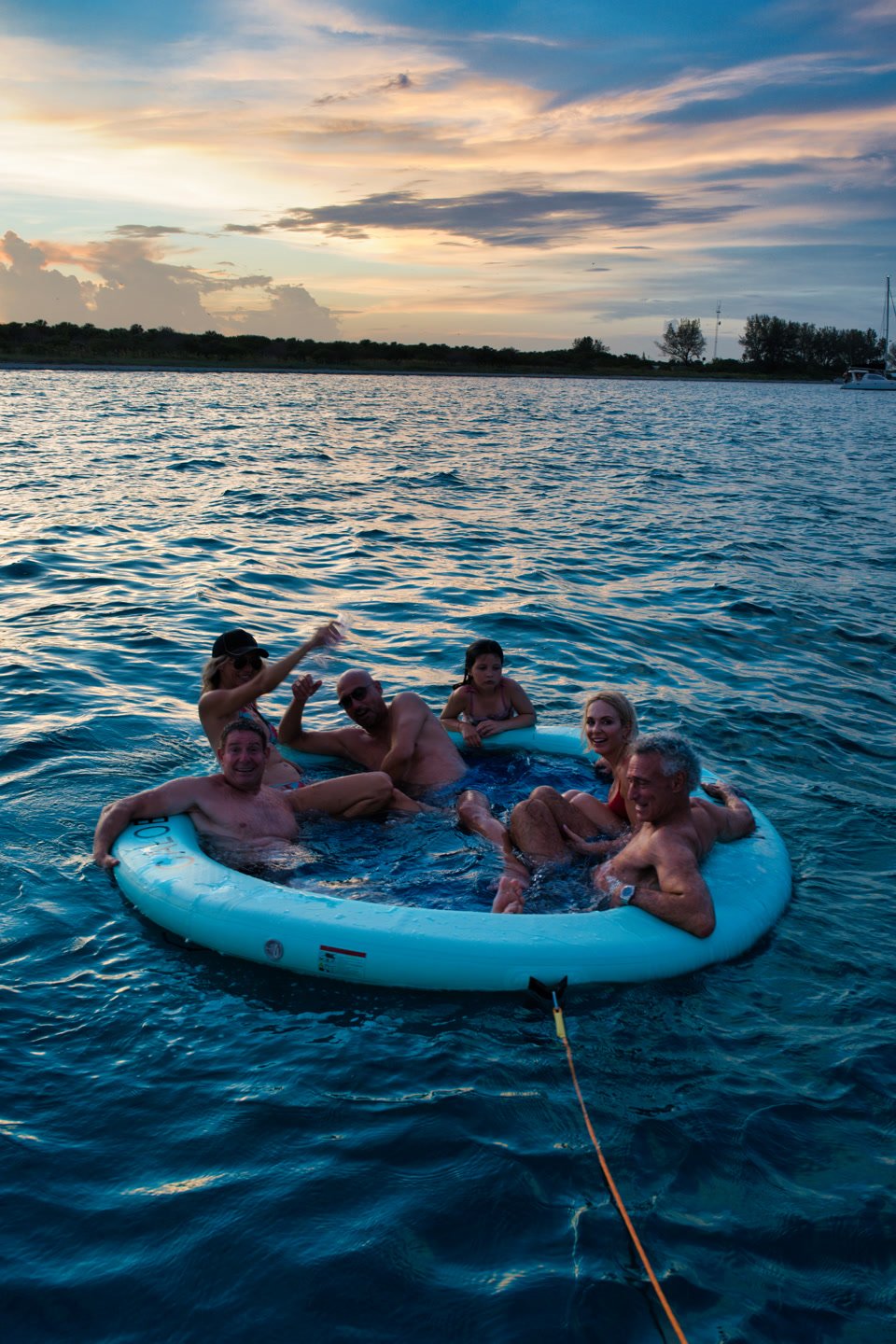 A group relaxing in the floating pool at dusk